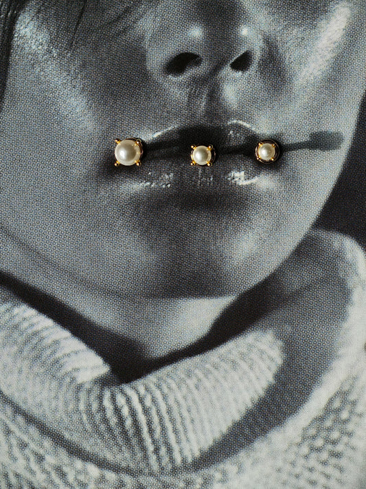 Flat lay of pearl flatback earring in 3 different sizes.