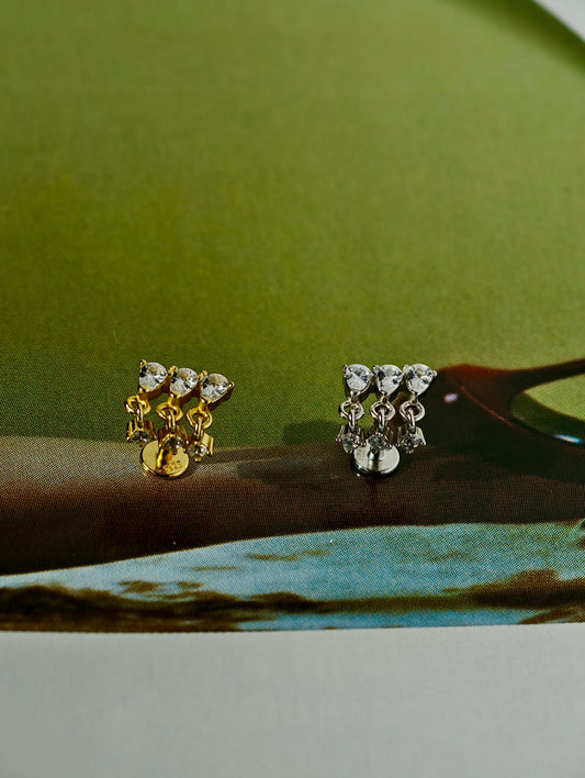 The glamorous CZ tassel earring arranged on a green surface, highlighting its luxurious and festive aesthetic.