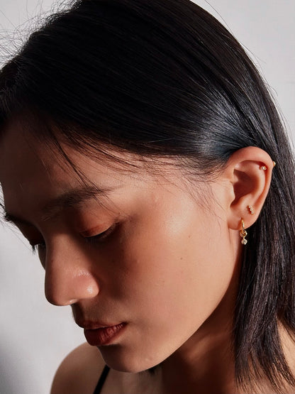 Model wearing shot of 2mm pearl flatback earring in helix