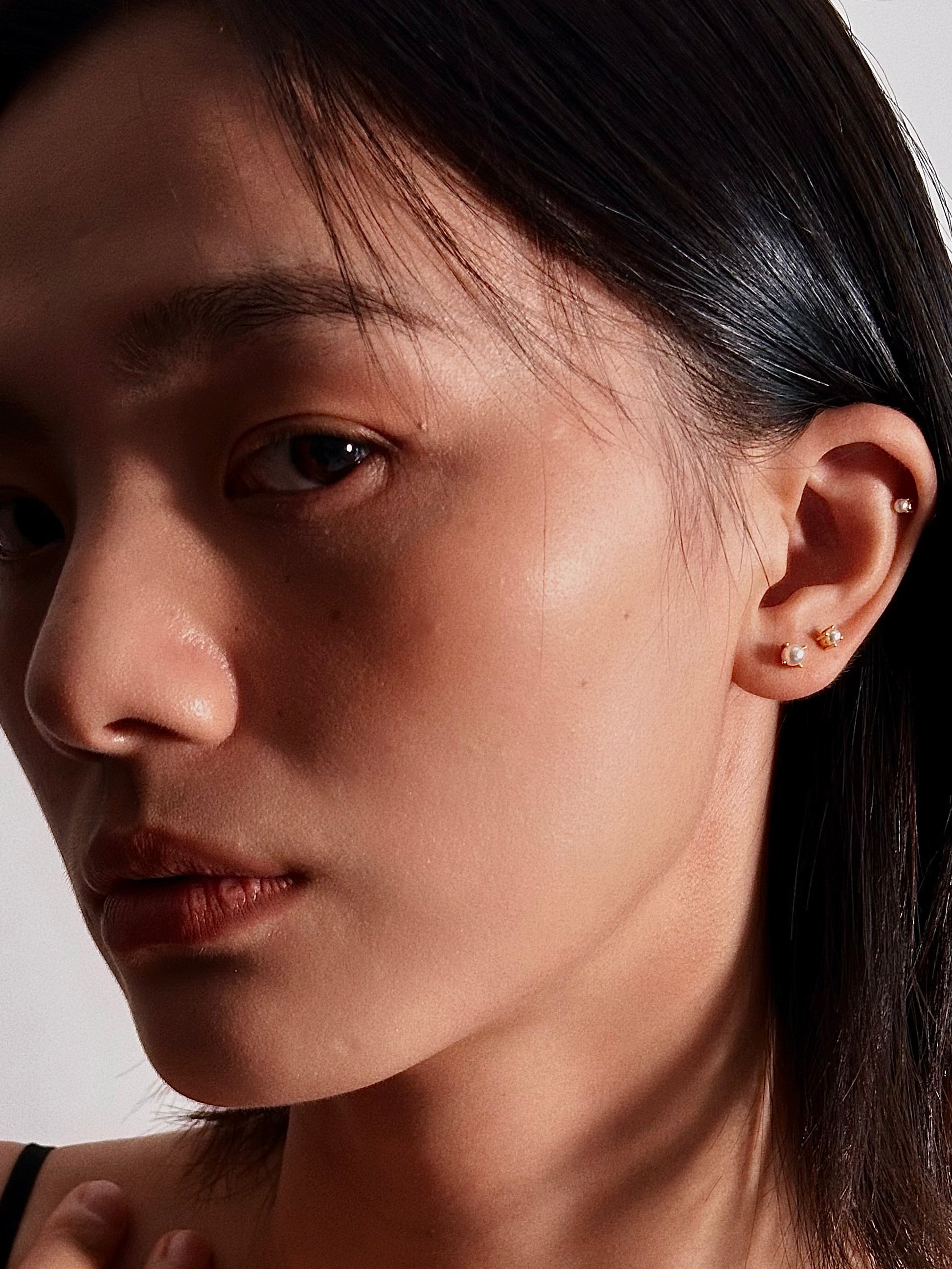 Model wearing shot of pearl flatback earring