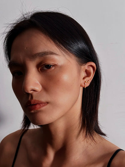 Woman wearing the marquise dangle flatback earring in a casual daytime setting, demonstrating their lightweight elegance and versatile style.