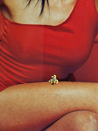 Flat lay composition showing the 3 Petals CZ earring