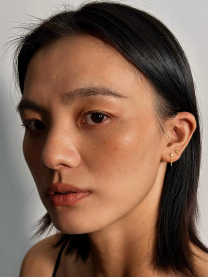 Model wearing photo of 3 Petals CZ Flatback Earring in 18k gold-plated sterling silver