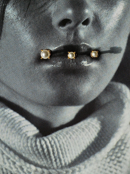 Flat lay of pearl flatback earring in 3 different sizes.